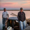 Two oystermen at dusk in East Bay, FL