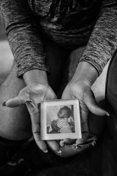 Keshena Williams, of Tacoma, Washington, holds the photo of her son, which kept her motivated to better hersel while in prison. That same son, now 18, was recently convicted and sent to prison.